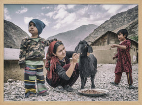 Kids and a goat in the village of Padrud Poster